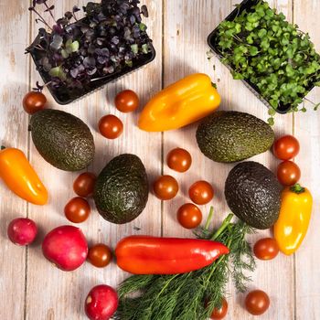 Assorted vegetables lying on a wooden table.