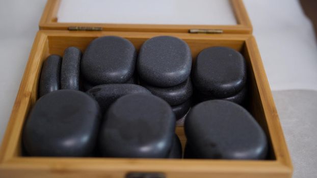 The doctor prepares stones for stone-therapy, pulls out of the box