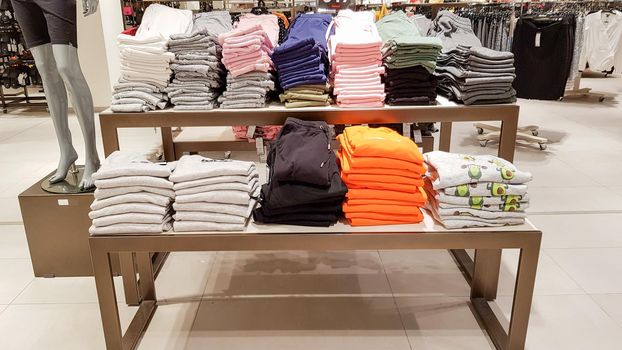 Ukraine, Kiev - September 04, 2019: A large clothing store, mannequins and many rows with hangers, a variety of sizes and colors. Black Friday, a day of shopping and sales at boutiques and malls.