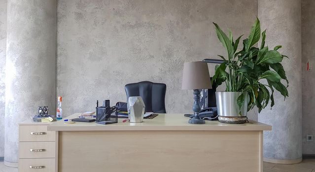 design of a workplace in the office with modern equipment and amenities on a gray wall background