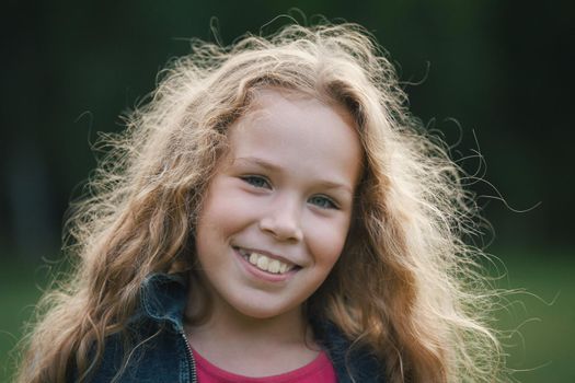 Sweet little girl outdoors - pretty smiling child, portrait