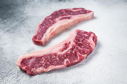 Striploin steak or New York steak, raw beef butchery meat cut. White background. Top view.