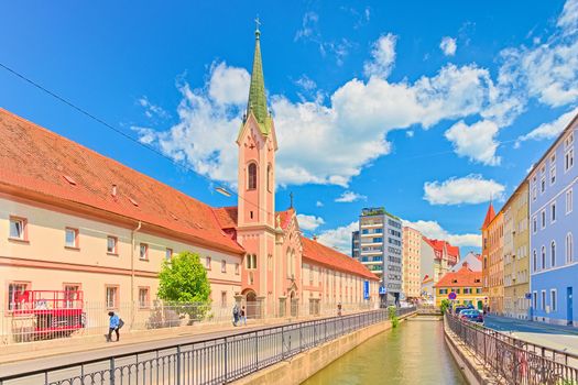 Graz - June 2020, Austria: View of the Pharmacy of the Elisabethinen hospital (Anstaltsapotheke des Krankenhauses d.Elisabethinen) and a canal with water