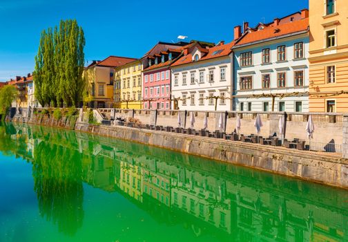 View of the Ljubljanica river in the center of Ljubljana. Colorful historical buildings reflected in the water