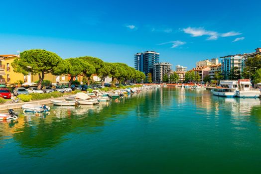 Cityscape of Grado, Italy. View of a canal with motorboats lying on the water
