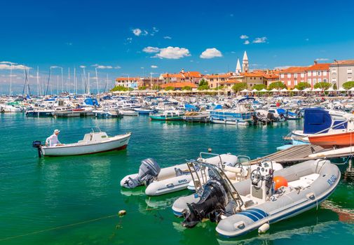 Izola - June 2020, Slovenia: A man in a motorboat is sailing to the Izola pier