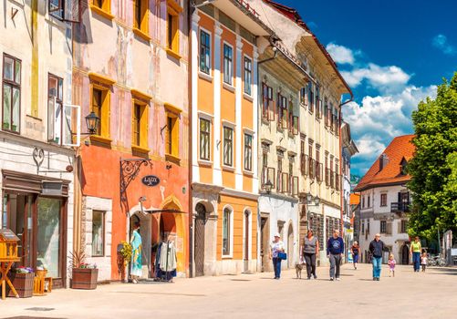 Škofja Loka - June 2020, Slovenia: View of the main street with people walking along the old historical buildings