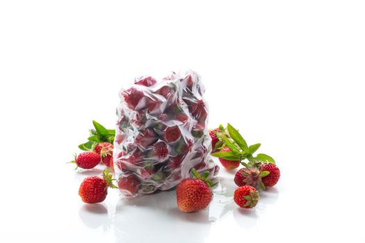 frozen fresh strawberries in a vacuum bag isolated on white background