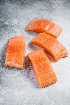 Raw salmon fillet steak on kitchen table. White background. Top view.