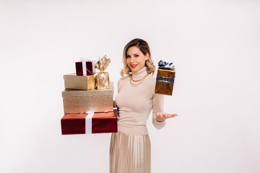 A girl in a skirt and jacket with a lot of gifts in her hands on a white background