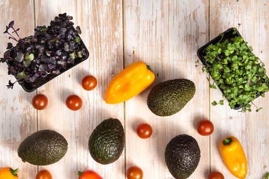 Assorted vegetables lying on a wooden table.