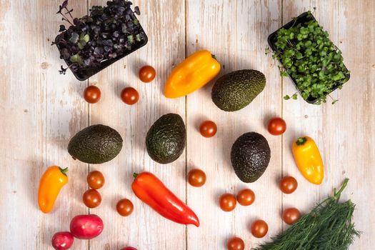 Assorted vegetables lying on a wooden table.