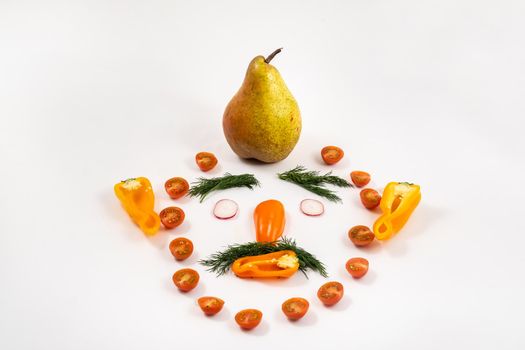 The face of a man made of sliced vegetables and a pear on his head on a white background.