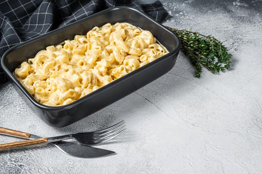 Mac and cheese american macaroni pasta with cheesy Cheddar sauce. White background. Top view. Copy space.