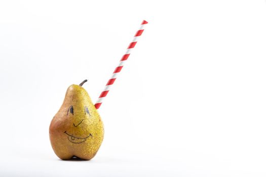 A large pear with a drinking tube sticking out of it on a white background.