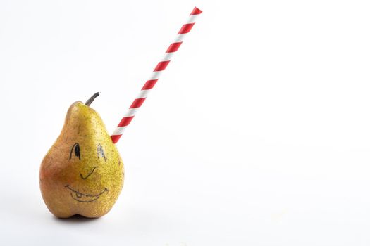 A large pear with a drinking tube sticking out of it on a white background.