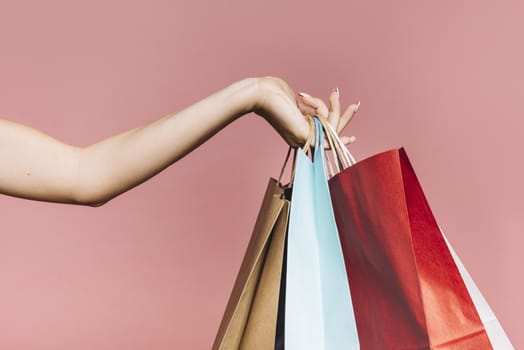 hand with colorful shopping bags