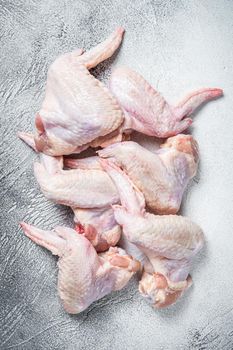 Raw chicken wings on a kitchen table. White background. Top view.