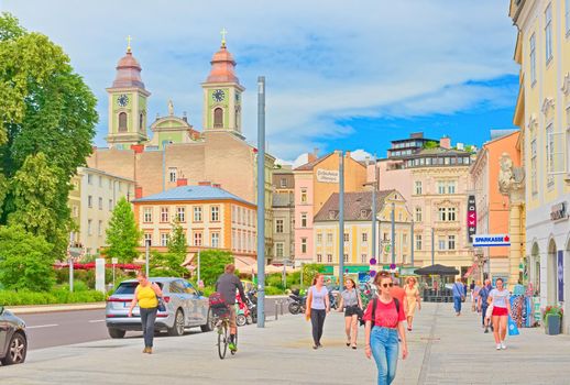Linz - June 2020, Austria: View of Linz city center with people walking along colorful historical buildings