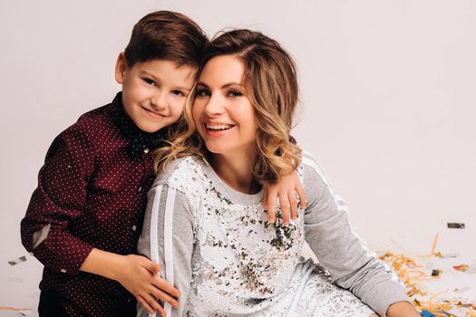 Portrait of a happy mother and son on a white background.