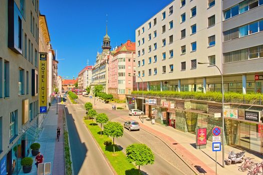 Maribor - June 2020, Slovenia: Street view with modern and old buildings, bus stop, shops, bars, a row of trees, and a hotel building (Ulica Kneza Koclja)