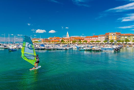 Izola - June 2020, Slovenia: A woman windsurfing in the harbor of Izola