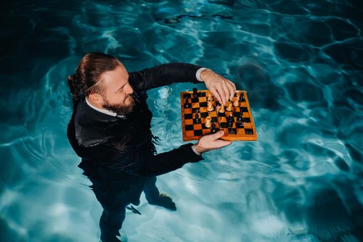 a man in a suit plays chess on the water in the pool.