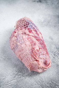 Boneless Leg of Lamb meat on butcher table. White background. Top view.