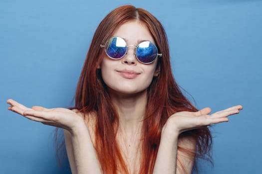 attractive woman with bare shoulders fashionable glasses blue background. High quality photo