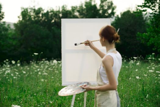 woman artist outdoors easel drawing creative landscape. High quality photo