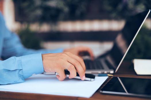 business man working on laptop outdoors. High quality photo