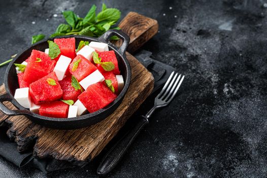 Healthy Organic Watermelon Salad with feta cheese. Black background. Top view. Copy space.