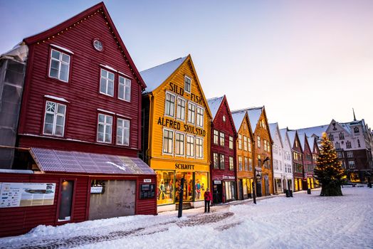 Bergen, Norway - December 27, 2014: Famous Bryggen street with wooden colored houses in Bergen at Christmas, Norway