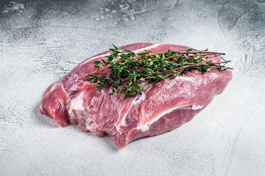 Raw pork shoulder meat on a butcher table. White background. Top view.