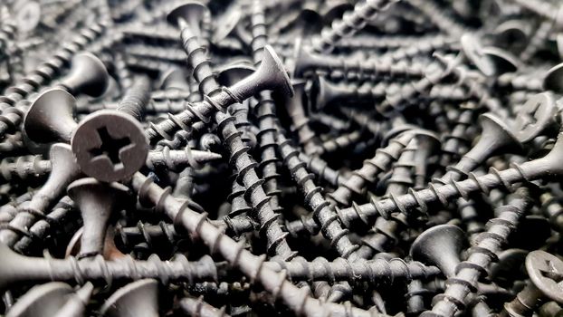 steel screws, metal screw, iron screw, screws as a background, wood screw. Iron or metal screw nails stack industrial building industry background