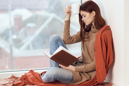 woman looking out the window on the windowsill Comfort weekend rest. High quality photo