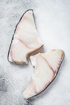 Raw Shark fish steaks on a kitchen table. White background. Top view.