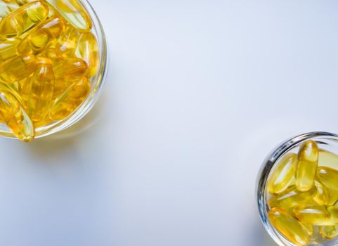 Fish oil capsules on a glass plate. A lot of vitamin omega 3 on a white background. Close-up, top view, high resolution product. Metabolism in the body. The body of calcium. A quick way to lose weight.