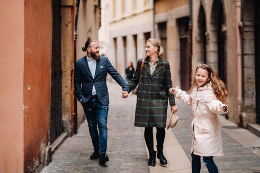 A beautiful family with strolls through the old city of Lyon in France.Family trip to the old cities of France.