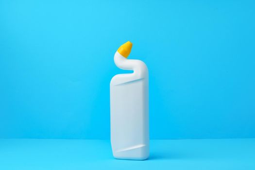 Liquid detergent for toilet cleaning on a blue background, close up