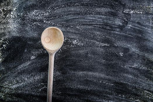 wooden spoon on a black textured table