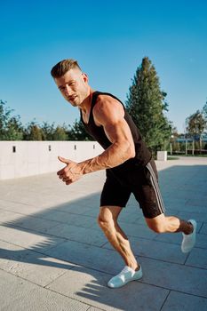 sporty man in the park with dumbbells workout fitness. High quality photo
