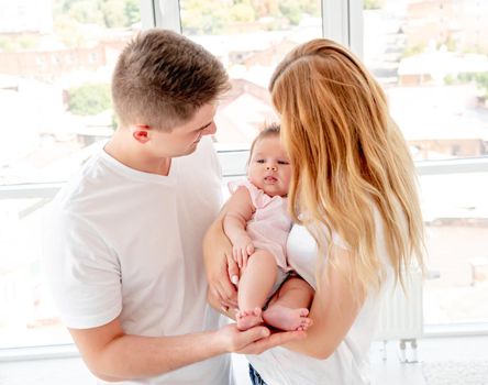 Young couple with beautiful baby at home