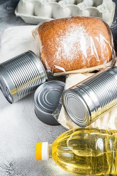 Donation food goods, quarantine help concept. Oil, canned food, pasta, bread, sugar, egg. White background. Top view.