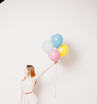 cheerful woman in a dress of colorful balloons. High quality photo