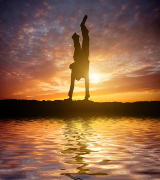 Little ballet dancer make handstand isolated on a white background