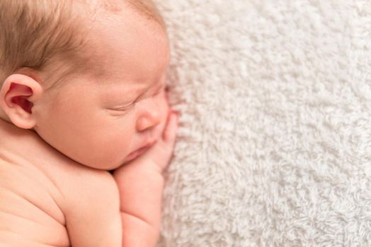 Sweet adorable child napping calmly after a long tough day, closeup