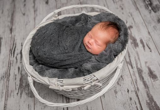 Infant sweetly napping in a small gray cradle, innocent and pure