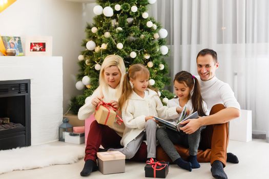 Happy family playing with Christmas gifts at home