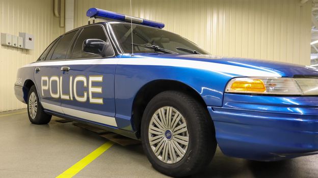 Police car Ford LTD Crown Victoria. Police car in blue with the word police in English. The passenger sedan was produced in 1991-2011. Ukraine, Kiev - June 09, 2021